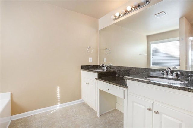 bathroom with vanity and a tub