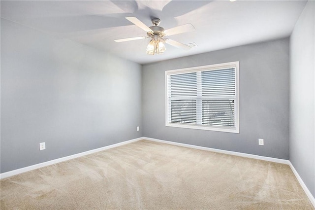 carpeted spare room featuring ceiling fan