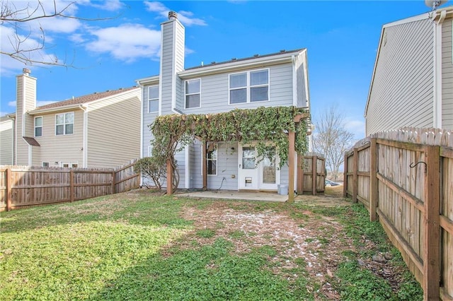 rear view of property with a patio area and a lawn