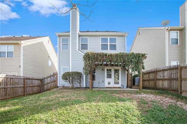 rear view of property with a yard and a patio area