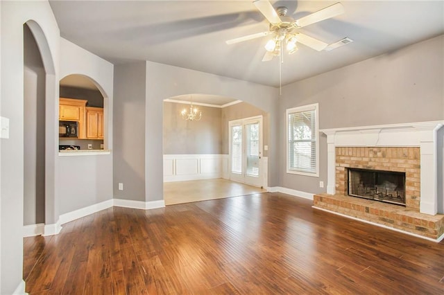 unfurnished living room with dark hardwood / wood-style flooring, ceiling fan, and a fireplace