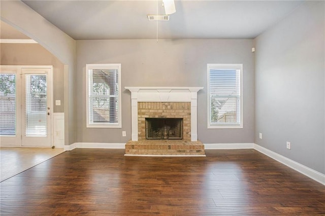 unfurnished living room with dark hardwood / wood-style flooring and a fireplace