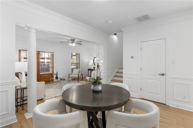 dining area with ceiling fan, ornamental molding, and light wood-type flooring