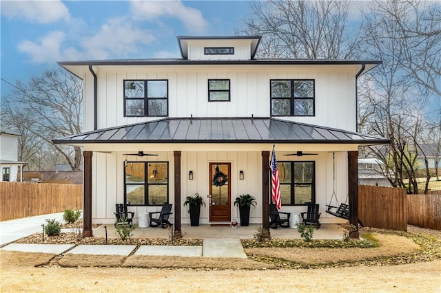 modern inspired farmhouse with a porch and ceiling fan