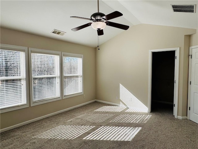 spare room featuring carpet flooring, ceiling fan, and vaulted ceiling