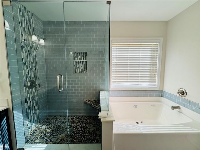 bathroom featuring vanity and independent shower and bath