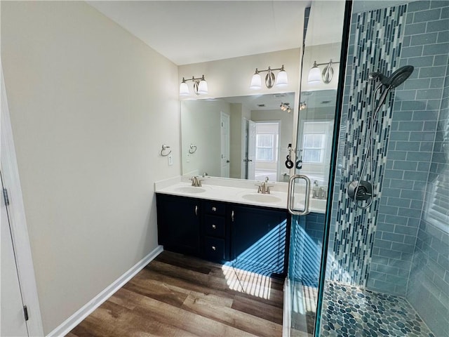 bathroom featuring hardwood / wood-style flooring, vanity, and a shower with shower door