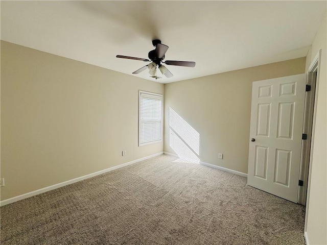 empty room featuring carpet floors and ceiling fan