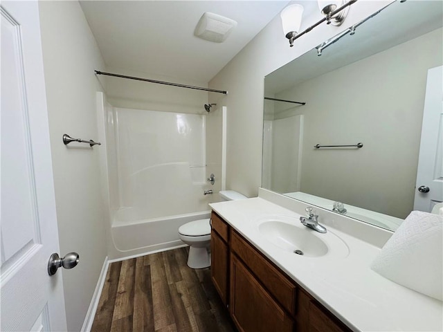 full bath with vanity, shower / washtub combination, wood finished floors, and toilet