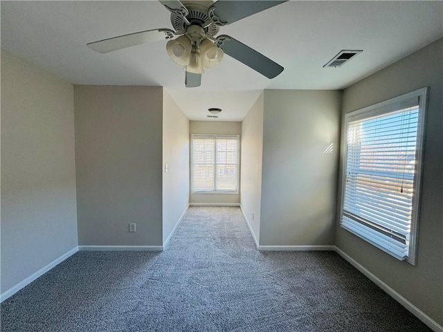 carpeted empty room featuring ceiling fan