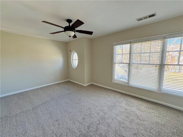 spare room featuring ceiling fan and carpet