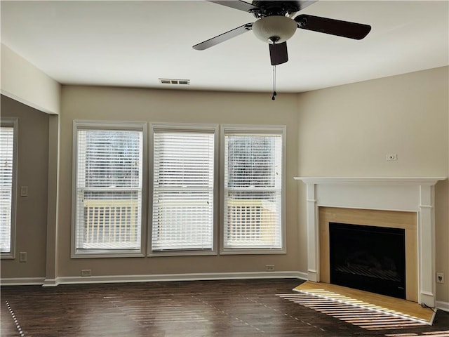 unfurnished living room with ceiling fan and dark hardwood / wood-style floors