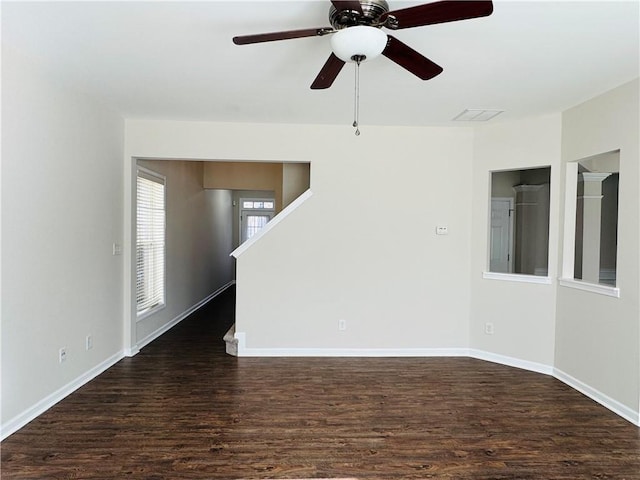 empty room featuring ceiling fan and dark wood-type flooring