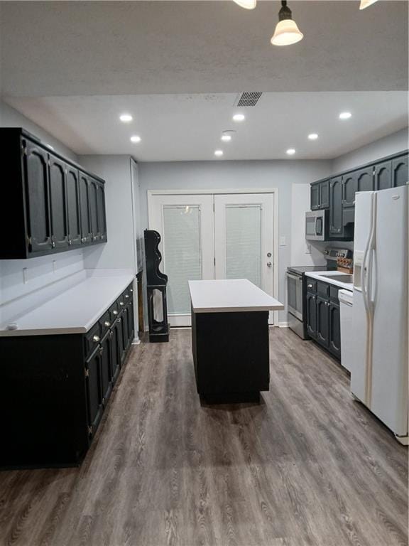 2218 Etowah River Rd, Dawsonville, GA 30534 - kitchen featuring appliances with stainless steel finishes, a center island, dark wood-style floors, light countertops, and recessed lighting
