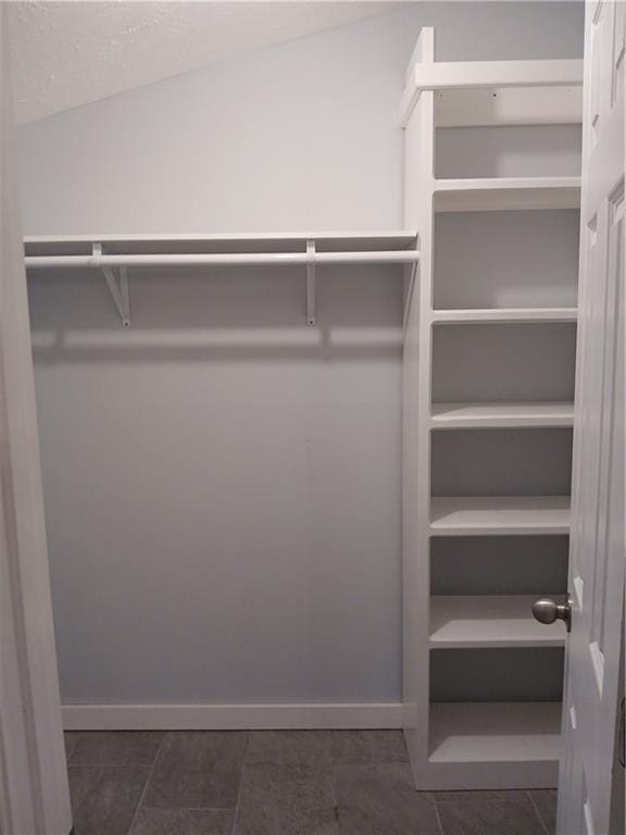 2218 Etowah River Rd, Dawsonville, GA 30534 - walk in closet featuring dark tile patterned floors