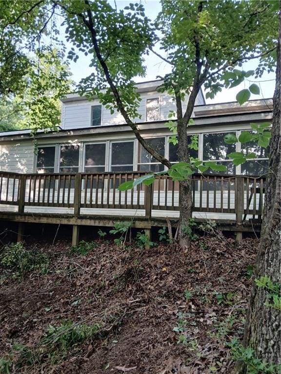 2218 Etowah River Rd, Dawsonville, GA 30534 - rear view of property featuring a wooden deck and a sunroom