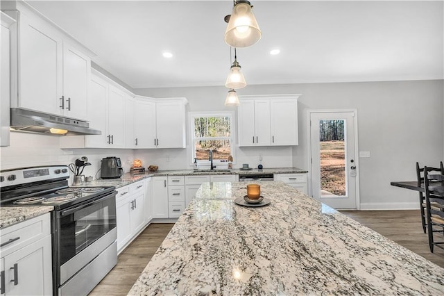 kitchen featuring white cabinetry, light stone counters, hanging light fixtures, and stainless steel range with electric cooktop