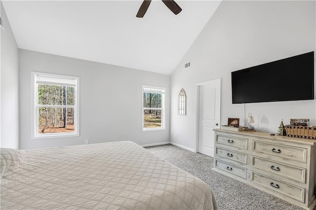 bedroom featuring multiple windows, ceiling fan, light carpet, and high vaulted ceiling