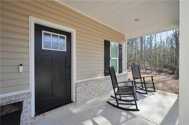 view of exterior entry with covered porch