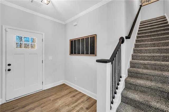 entrance foyer with crown molding and hardwood / wood-style floors