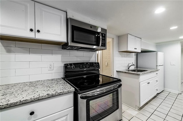 kitchen with white cabinetry, sink, tasteful backsplash, and appliances with stainless steel finishes