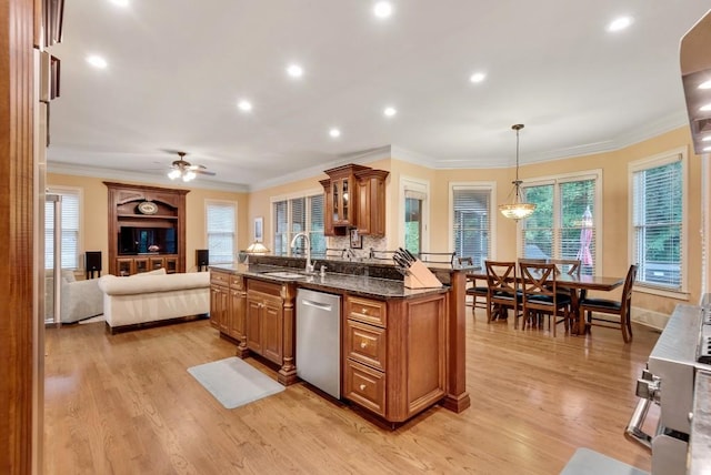 kitchen with dishwasher, a sink, brown cabinetry, light wood-style flooring, and crown molding