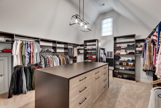 spacious closet featuring light colored carpet and lofted ceiling