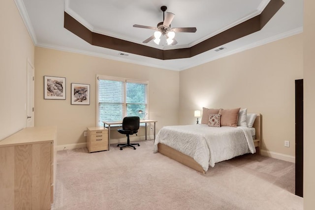 bedroom with a tray ceiling, crown molding, light colored carpet, an office area, and baseboards