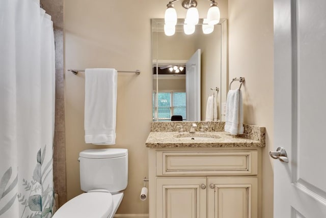 full bathroom featuring toilet, vanity, and curtained shower