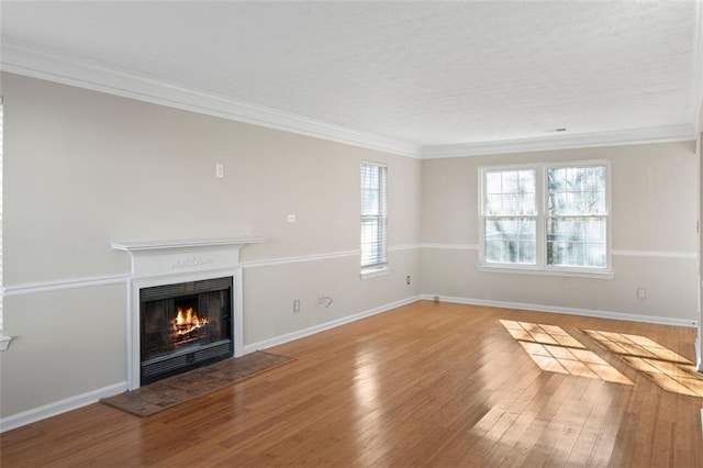 unfurnished living room featuring light wood-type flooring and ornamental molding