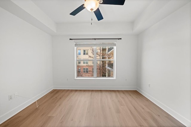 empty room with light wood-style flooring, baseboards, and ceiling fan