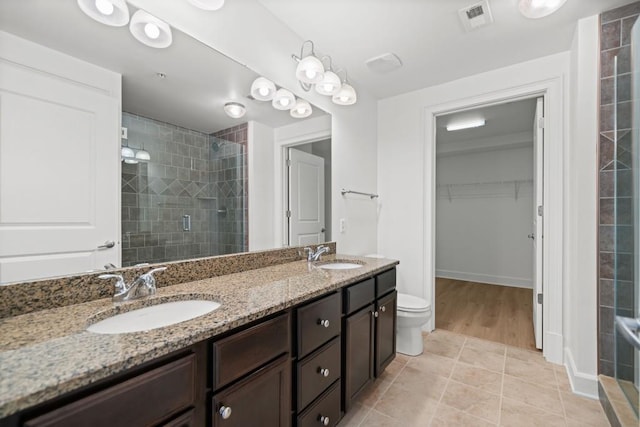 bathroom with a sink, visible vents, and a shower stall