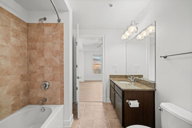 bathroom with toilet, vanity, shower / tub combination, tile patterned flooring, and baseboards