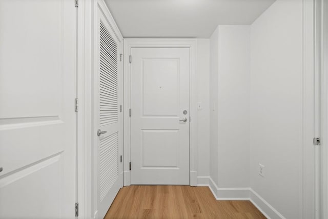 entryway featuring light wood-style flooring and baseboards