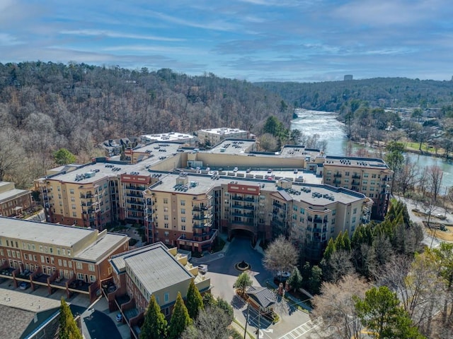 birds eye view of property featuring a wooded view