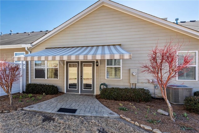 view of front of house featuring french doors and central AC