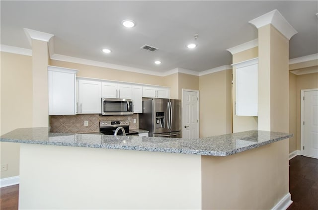 1965 Nocturne Dr Unit 1306A, Alpharetta, GA 30009 - kitchen with appliances with stainless steel finishes, a peninsula, crown molding, light stone counters, and baseboards