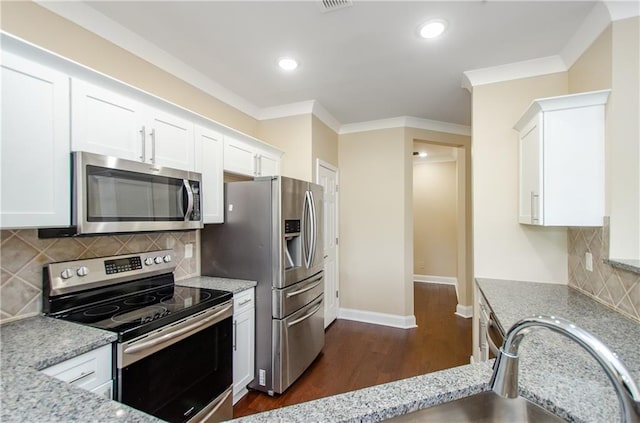 1965 Nocturne Dr Unit 1306A, Alpharetta, GA 30009 - kitchen featuring stainless steel appliances, white cabinets, dark wood finished floors, light stone countertops, and crown molding