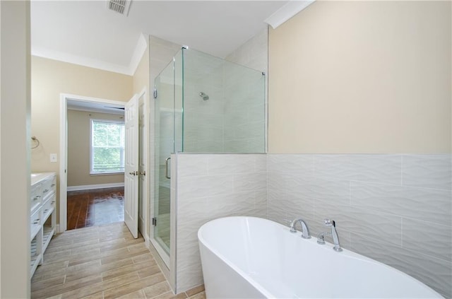 1965 Nocturne Dr Unit 1306A, Alpharetta, GA 30009 - full bathroom with a freestanding tub, a shower stall, tile walls, vanity, and crown molding