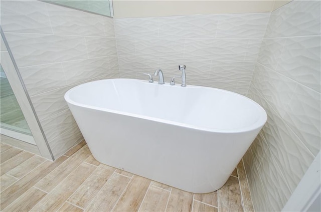1965 Nocturne Dr Unit 1306A, Alpharetta, GA 30009 - full bath with a freestanding bath, wood finished floors, and tile walls