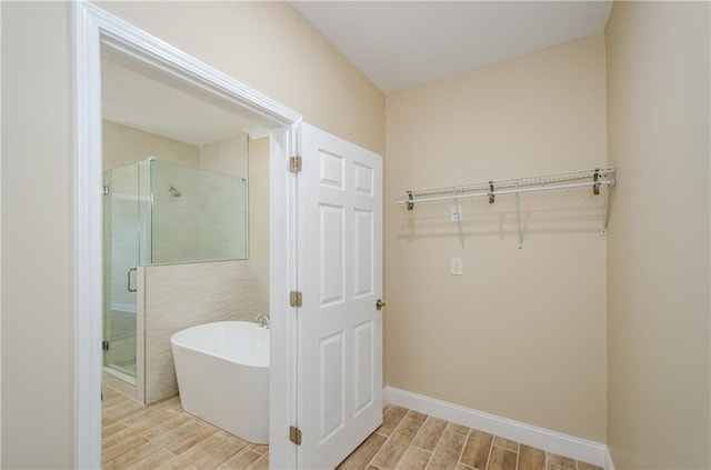1965 Nocturne Dr Unit 1306A, Alpharetta, GA 30009 - bathroom with a freestanding bath, wood tiled floors, a stall shower, and baseboards