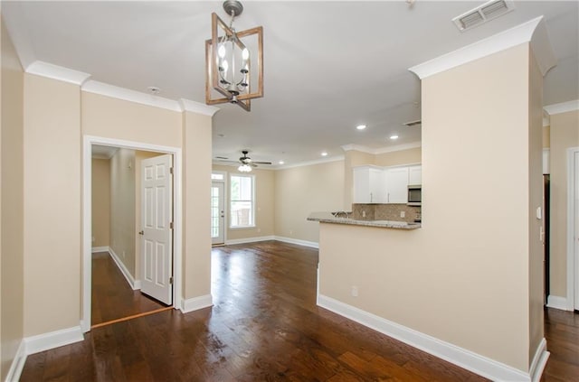 1965 Nocturne Dr Unit 1306A, Alpharetta, GA 30009 - kitchen featuring stainless steel microwave, ceiling fan, crown molding, a chandelier, and tasteful backsplash
