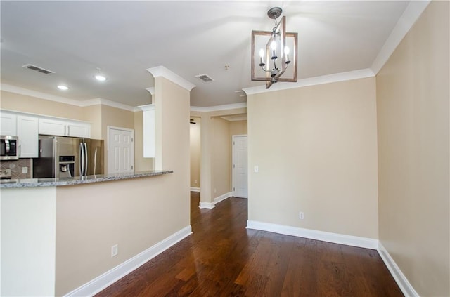 1965 Nocturne Dr Unit 1306A, Alpharetta, GA 30009 - kitchen featuring appliances with stainless steel finishes, light stone counters, white cabinetry, crown molding, and dark wood finished floors