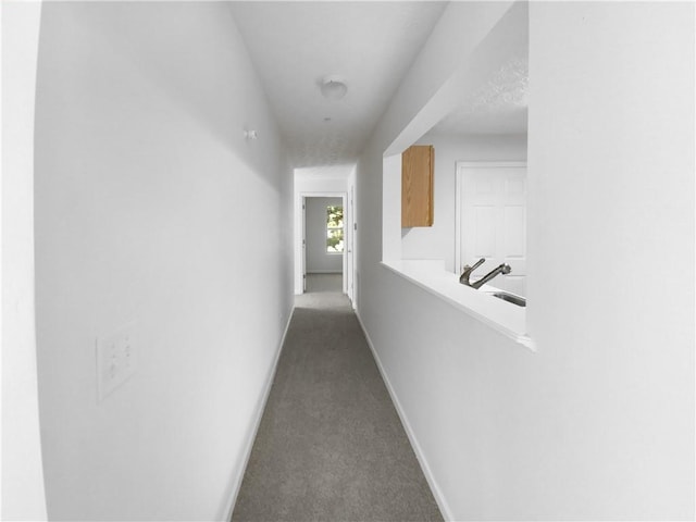 3217 Fairington Dr, Lithonia, GA 30038 - corridor featuring a sink and dark carpet