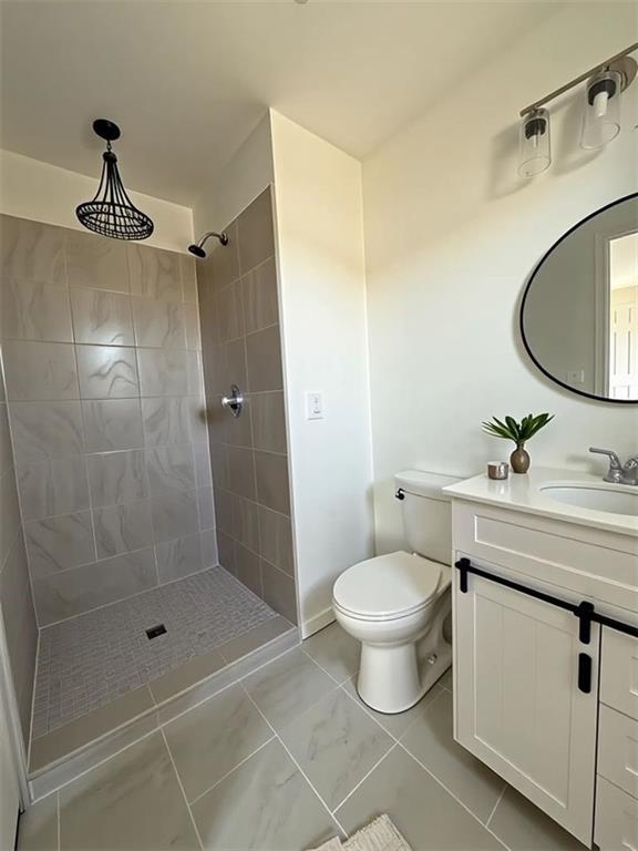 2873 Shoals Hill Ct, Dacula, GA 30019 - bathroom with vanity and a tile shower