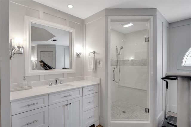 bathroom featuring vanity and a shower stall