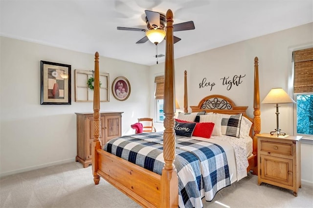 bedroom with baseboards, light colored carpet, and a ceiling fan