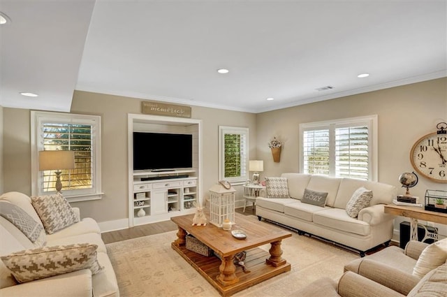 living area featuring crown molding, recessed lighting, wood finished floors, and visible vents