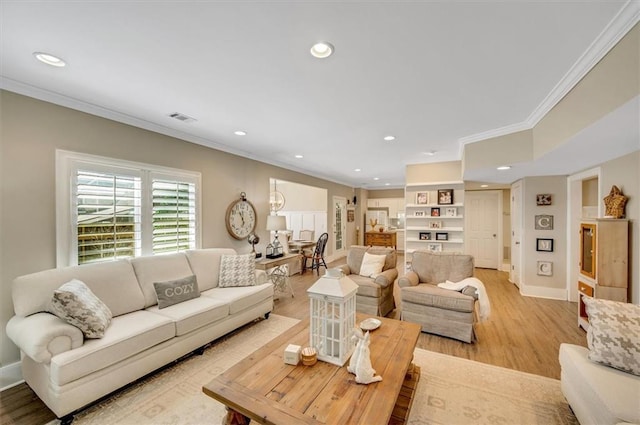 living room with recessed lighting, visible vents, light wood-style flooring, and crown molding