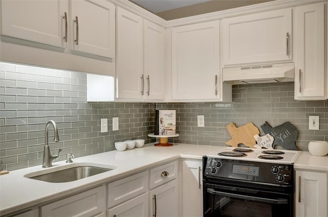 kitchen with under cabinet range hood, black range with electric cooktop, white cabinets, and a sink